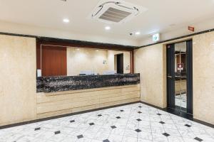 a lobby of a hotel with a reception desk at アメ村ガーデンホテルAmemura Garden Hotel in Osaka