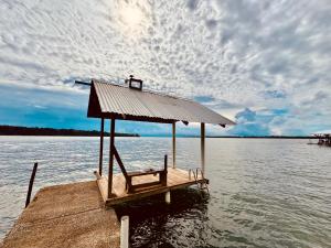 a bench on a dock on a body of water at Bocas Sunset Beach House in Bocas Town