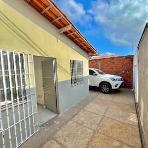 a car parked next to a building with a garage at Casa Barreirinhas in Barreirinhas +2 photos