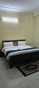 a large bed in a room with at Pb Legacy hotel in Noida