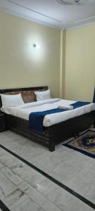 a bedroom with a large bed in a room at Pb Legacy hotel in Noida