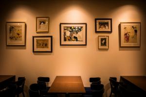 a dining room with a table and pictures on the wall at Sotetsu Fresa Inn Ginza-Nanachome in Tokyo