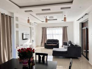a living room with a couch and a table at Villa with 4 bedrooms in Lusaka