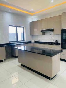 a large kitchen with a large island in the middle at Villa with 4 bedrooms in Lusaka
