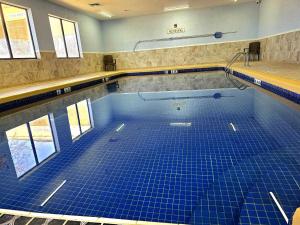 a swimming pool with blue tiles on the floor at Comfort Inn Ottawa Kansas in Ottawa