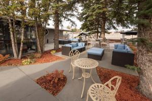 a patio with chairs and a table and chairs at Clarion Pointe Medicine Hat Saamis Tepee in Medicine Hat