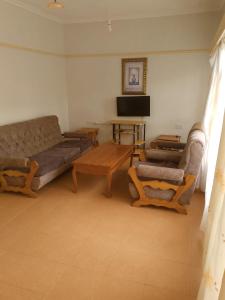 a living room with a couch and a table at Taita Rocks Hotel in Wundanyi