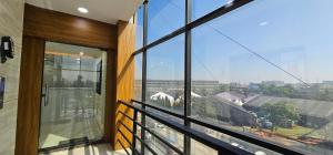 a balcony with a view of a city at Hotel Empire in Vapi