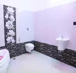a bathroom with a toilet and a sink at The Sunshine Villa in Pondicherry +13 photos