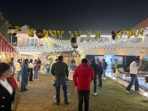 a group of people standing in front of a building with lights at Friends Villa Nainwal in Gurgaon +47 photos