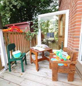 a patio with a table and two chairs on a porch at Ferienwohnung Am Hohen Berge in Lauenburg +7 photos