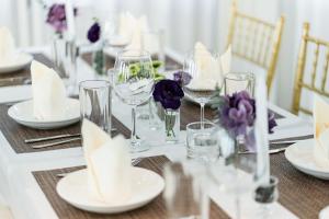 a table with wine glasses and purple flowers on it at After Rain Hotel in Chiang Mai +104 photos