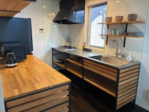 a kitchen with a sink and a counter top at Aoshima Seaside Village in Miyazaki