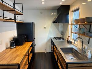 a kitchen with a sink and a counter top at Aoshima Seaside Village in Miyazaki +5 photos