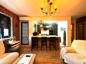 a kitchen and living room with a table and chairs at ForestView Dream Apartment in Bucharest