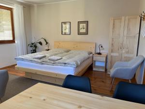 a bedroom with a bed and a table and chairs at Privát Kováč in Tatranská Lomnica