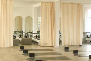 a room with curtains and yoga mats on the floor at Mira Mirissa in Mirissa