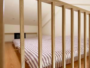 a bunk bed in a room with a staircase at 宜蘭好窄平價民宿 in Zhuangwei