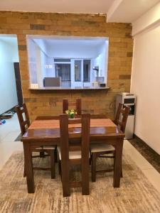 a wooden dining room table and chairs in a room at LJ Homes in Nairobi