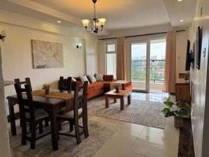 a living room with a table and a couch at LJ Homes in Nairobi