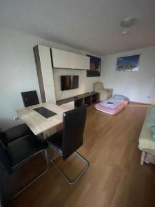 a living room with a dining room table and chairs at Cosy Accommodation - very central in Munich