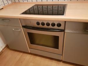 a kitchen with a stove and a counter top at Cosy Accommodation - very central in Munich