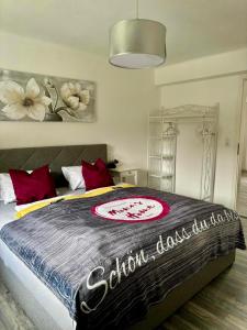 a bedroom with a large bed with red pillows at Apartment Mona´s Home in Sankt Pankraz +50 photos