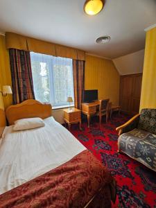 a hotel room with a bed and a desk at Folwark Historic Hotel in Warsaw