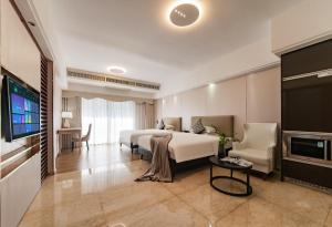 a hotel room with a bed and a tv at RoomMe HOTEL寓洣公寓佛山铂顿祖庙岭南天地店 in Foshan