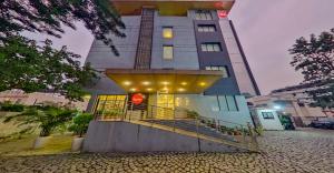 a tall building with a staircase in front of it at Spree Hotel Kriday Rajpur Road Dehradun in Dehradun