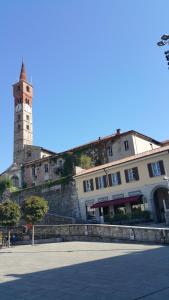a building with a clock tower on a hill at Mid Mod in Cantù