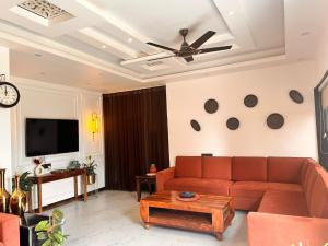 a living room with a couch and a tv at Friends Villa Nainwal in Gurgaon