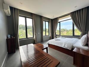 a hotel room with a bed and windows at Alicia Resort in Koh Rong Island