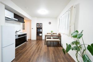 a kitchen and dining room with a table at 新築Sunbright Asakusa 101 in Tokyo +19 photos