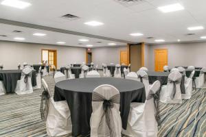 a banquet hall with tables and chairs with bows at Quality Inn & Suites Monroe in Monroe +49 photos