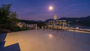 a view of a balcony at night with the moon at Gapyeong Boreum-Dal Poolvilla in Gapyeong +4 photos