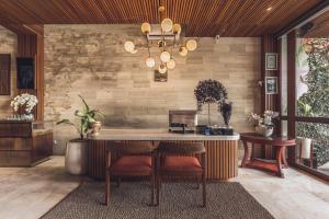 a kitchen with a table and chairs in a room at Sana Vie Villa Seminyak by Ini Vie Hospitality in Seminyak