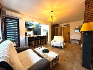 a living room with a couch and a table at ForestView Dream Apartment in Bucharest +49 photos