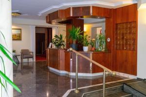 a lobby with a staircase and a wine cellar at Hotel Lorösch in Bad Orb