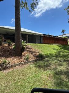 a building with a tree and a fence at The Ponds at Mudgeeraba in Gold Coast