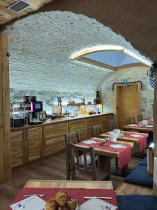 a restaurant with tables and a kitchen in a room at Chalet La Rugiada in Bormio
