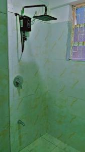 a shower with a shower head in a bathroom at Taita Rocks Hotel in Wundanyi