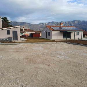 an empty parking lot in front of a house at Villa Germini in Polje Čepić +2 photos