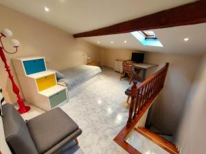 a room with a bed and a desk with a computer at Cal Pataqué, house in Arnes in Arnés