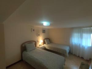 a hotel room with two beds and a window at Cal Pataqué, house in Arnes in Arnés