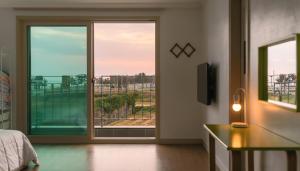 a bedroom with a sliding glass door with a view at Gyeongju Gamposole Pension in Gyeongju