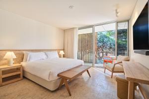 a bedroom with a bed and a large window at The Lodge Wadjemup in Rottnest Island +30 photos