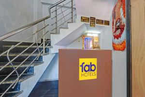 a building with a fico house sign next to stairs at Via Lords inn in Bhopal
