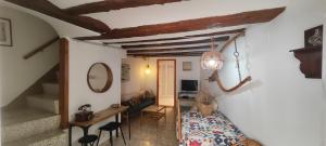 a room with a staircase and a table and chairs at Cal Pataqué, house in Arnes in Arnés