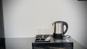 a coffee maker sitting on top of a stove at Skyscenic Munnar in Munnar
